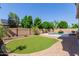 Landscaped backyard with a pool, artificial turf, and brick-paved patio ideal for entertaining at 882 E Parkview Dr, Gilbert, AZ 85295