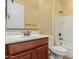 Bathroom features a wooden vanity with white countertop and framed mirror at 882 E Parkview Dr, Gilbert, AZ 85295