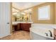 Relaxing bathroom with soaking tub, vanity area, and traditional fixtures at 882 E Parkview Dr, Gilbert, AZ 85295