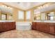 Inviting bathroom with soaking tub, double sinks and vanity, and tile flooring at 882 E Parkview Dr, Gilbert, AZ 85295