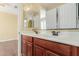 Double sink bathroom features wood cabinetry and a shared mirror at 882 E Parkview Dr, Gilbert, AZ 85295