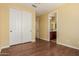 Bedroom featuring double door closet, hardwood floors, and entrance to ensuite bathroom at 882 E Parkview Dr, Gilbert, AZ 85295