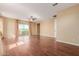 Bright bedroom with hardwood floors, neutral walls, and sliding glass doors to a balcony at 882 E Parkview Dr, Gilbert, AZ 85295