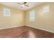 Bedroom featuring hardwood floor, a ceiling fan, yellow walls and bright windows at 882 E Parkview Dr, Gilbert, AZ 85295