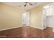 Bedroom featuring hard wood floors and an open closet and bedroom door at 882 E Parkview Dr, Gilbert, AZ 85295