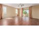 Spacious bedroom featuring hardwood floors, a ceiling fan, and sliding glass doors to a balcony at 882 E Parkview Dr, Gilbert, AZ 85295