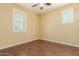 Bedroom with hard wood floors, ceiling fan, yellow walls and bright windows at 882 E Parkview Dr, Gilbert, AZ 85295