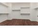 Walk-in closet with built-in shelving and hardwood floors at 882 E Parkview Dr, Gilbert, AZ 85295