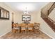 Spacious dining room with modern light fixture, large mirror, staircase, and elegant decor at 882 E Parkview Dr, Gilbert, AZ 85295