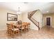 Bright dining room showcasing a large table, chandelier, staircase, and tile floors at 882 E Parkview Dr, Gilbert, AZ 85295