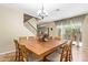 Dining room features a large square table, wood chairs, stairs, and bright windows at 882 E Parkview Dr, Gilbert, AZ 85295