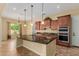 Well-appointed kitchen with island, granite countertops and stainless steel appliances at 882 E Parkview Dr, Gilbert, AZ 85295