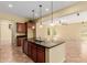 Stylish kitchen featuring an island, granite countertops and dark wood cabinets at 882 E Parkview Dr, Gilbert, AZ 85295