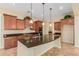 Gourmet kitchen with island, granite countertops and stainless steel appliances at 882 E Parkview Dr, Gilbert, AZ 85295