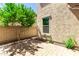 Cozy backyard patio area with brick pavers and a young, leafy tree at 882 E Parkview Dr, Gilbert, AZ 85295