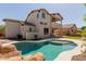 Home's backyard features a sparkling pool with rock detail at 882 E Parkview Dr, Gilbert, AZ 85295