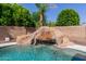 Close up of the pool's rock waterfall feature, creating a tranquil oasis in the backyard at 882 E Parkview Dr, Gilbert, AZ 85295