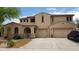 Charming two-story home featuring a spacious three car garage and arched porch at 15241 W Coolidge St, Goodyear, AZ 85395