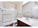 Standard bathroom with a dark wood vanity, shower and tub combination with glass door at 15387 W Columbine Dr, Surprise, AZ 85379