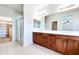 Bathroom features a double sink vanity, walk-in shower, and tile flooring at 15387 W Columbine Dr, Surprise, AZ 85379