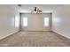 Bright bedroom with a neutral color palette, carpet, and shuttered windows at 15387 W Columbine Dr, Surprise, AZ 85379