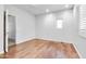 Bright bedroom featuring hardwood floors, a ceiling fan, and plantation shutters for adjustable natural light at 15387 W Columbine Dr, Surprise, AZ 85379