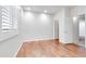 Bright bedroom featuring hardwood floors, plantation shutters, and easy access to other rooms at 15387 W Columbine Dr, Surprise, AZ 85379