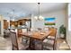 Dining area adjacent to the kitchen, featuring modern lighting and a stylish table setting at 15387 W Columbine Dr, Surprise, AZ 85379