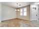 Empty dining area featuring tile flooring and an elegant chandelier at 15387 W Columbine Dr, Surprise, AZ 85379