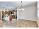 Open-concept kitchen and dining area with stainless steel appliances and tile flooring at 15387 W Columbine Dr, Surprise, AZ 85379