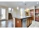 Open kitchen with a center island, stainless steel appliances, and tile flooring adjoining a stairway at 15387 W Columbine Dr, Surprise, AZ 85379