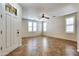 Spacious room with tile floors, plantation shutters, and neutral paint at 15387 W Columbine Dr, Surprise, AZ 85379