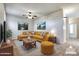 Staged living room featuring a comfortable sofa, area rug, and tasteful decor at 15387 W Columbine Dr, Surprise, AZ 85379