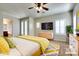 Staged main bedroom with carpet, large windows, and modern furnishings at 15387 W Columbine Dr, Surprise, AZ 85379