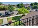 View of a lush neighborhood with well-maintained lawns and mature trees from a balcony at 15387 W Columbine Dr, Surprise, AZ 85379