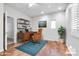 Bright office space with hardwood floors, accent rug, built-in shelving, and a vintage desk at 15387 W Columbine Dr, Surprise, AZ 85379