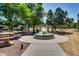 Community park with inviting pathways, lush greenery, picnic tables, and playgrounds for outdoor activities at 15387 W Columbine Dr, Surprise, AZ 85379