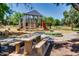 Community playground with climbing structure, slides, a picnic bench, and well-maintained landscaping at 15387 W Columbine Dr, Surprise, AZ 85379