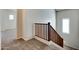 Carpeted stairway with wooden railing and natural light filtering through a window at 15387 W Columbine Dr, Surprise, AZ 85379