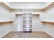 Walk-in closet with built-in shelving and ample storage space for clothes and accessories at 15387 W Columbine Dr, Surprise, AZ 85379