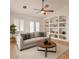 Bright living room with white couch, ceiling fan, and decorative shelving at 1625 E Clover St, Casa Grande, AZ 85122