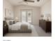 Spacious bedroom featuring neutral tones, decorative dresser, and french doors at 1625 E Clover St, Casa Grande, AZ 85122