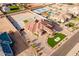 Expansive aerial view of a custom home with manicured landscaping, a circular driveway, and a terracotta tile roof at 16368 W Watkins St, Goodyear, AZ 85338