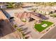 Expansive aerial view of a custom home with manicured landscaping, a circular driveway, and a terracotta tile roof at 16368 W Watkins St, Goodyear, AZ 85338