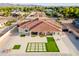 Aerial view showcasing a large home with a putting green and a modern artificial turf feature in the backyard at 16368 W Watkins St, Goodyear, AZ 85338