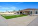 The backyard features an expansive patio with artificial turf and a putting green, perfect for outdoor activities at 16368 W Watkins St, Goodyear, AZ 85338