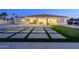 A spacious backyard features an expansive patio with a putting green for outdoor enjoyment at 16368 W Watkins St, Goodyear, AZ 85338