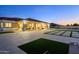 Expansive backyard and patio with modern concrete block design with putting green to enjoy in the evenings at 16368 W Watkins St, Goodyear, AZ 85338