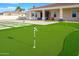The backyard features a putting green with artificial turf sections, offering a fun and relaxing recreational area at 16368 W Watkins St, Goodyear, AZ 85338