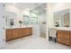 Light and airy bathroom with double sinks, a glass shower, and vanity space at 16368 W Watkins St, Goodyear, AZ 85338